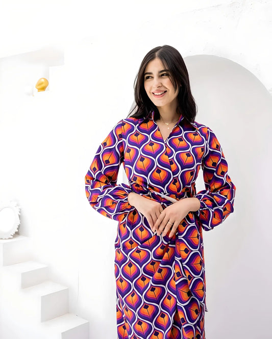 Woman wearing a bold geometric print crepe fabric maxi dress in vibrant colors.