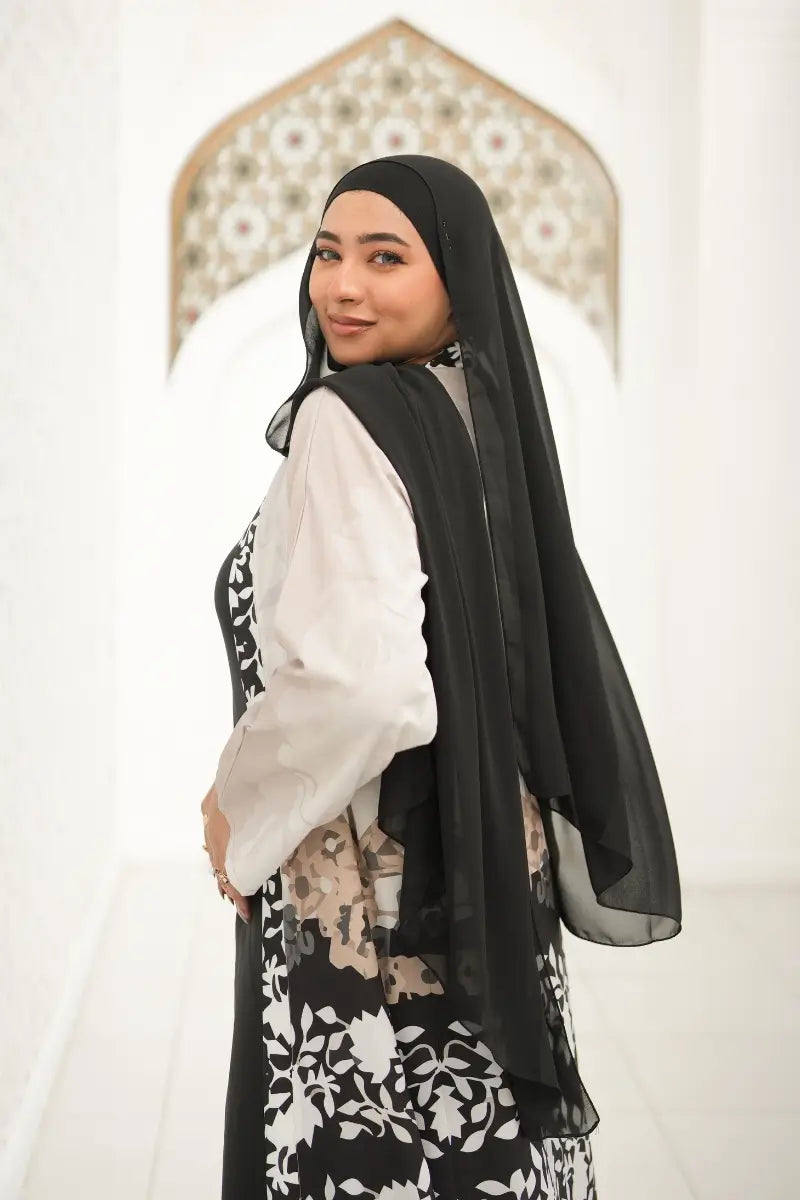 Elegant Black and White Floral Printed Abaya made from premium silk and cotton blend, showcasing a timeless design for modest fashion
