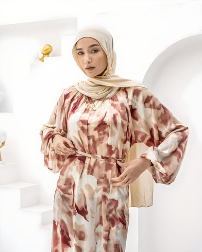 Stylish abstract floral maxi dress with gathered waist and belt.