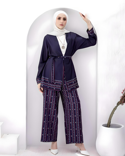 Woman wearing a navy blue patterned soft crepe fabric suit with a white hijab.