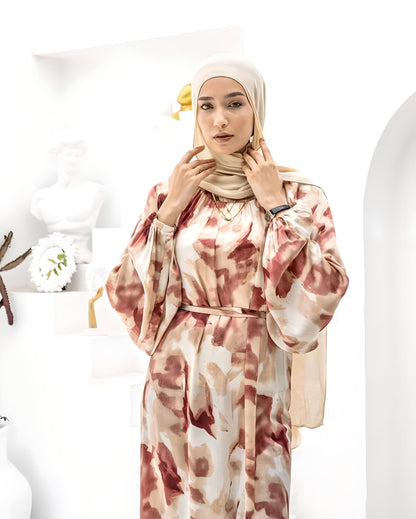 Modern modest outfit featuring a floral print dress and beige hijab.
