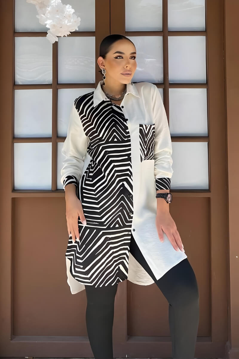 Front view of a black and white button-up long sleeve blouse with a geometric print in rayon slub fabric.