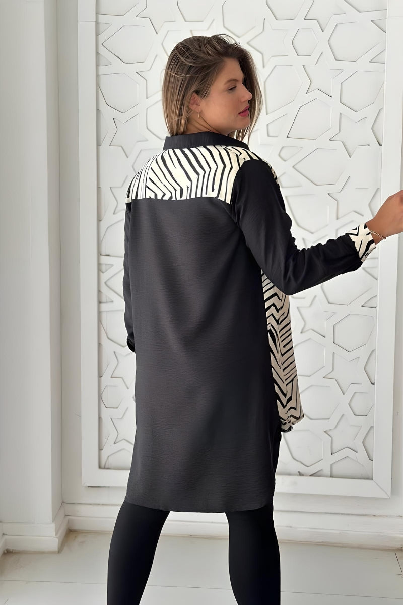 Close-up of the cuffs on a black and white geometric print blouse, highlighting the rayon slub fabric and design.