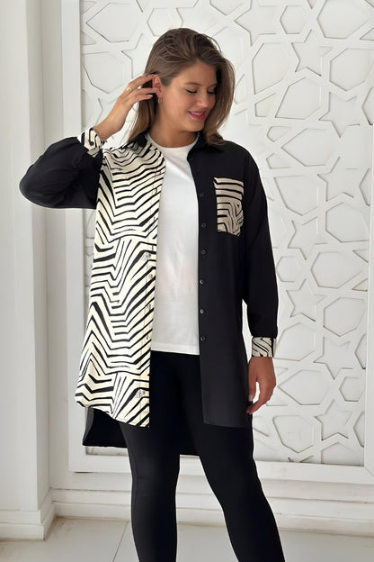 Front view of a black and white button-up blouse with a geometric print, crafted from rayon slub fabric.