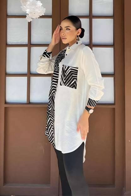 Side view of a black and white geometric print blouse with long sleeves, showing the unique pattern design.