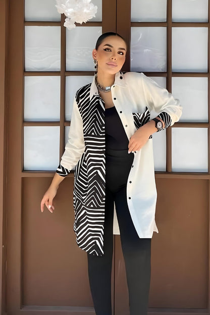 Close-up of the cuffs on a black and white geometric print blouse, highlighting the rayon slub fabric and design.