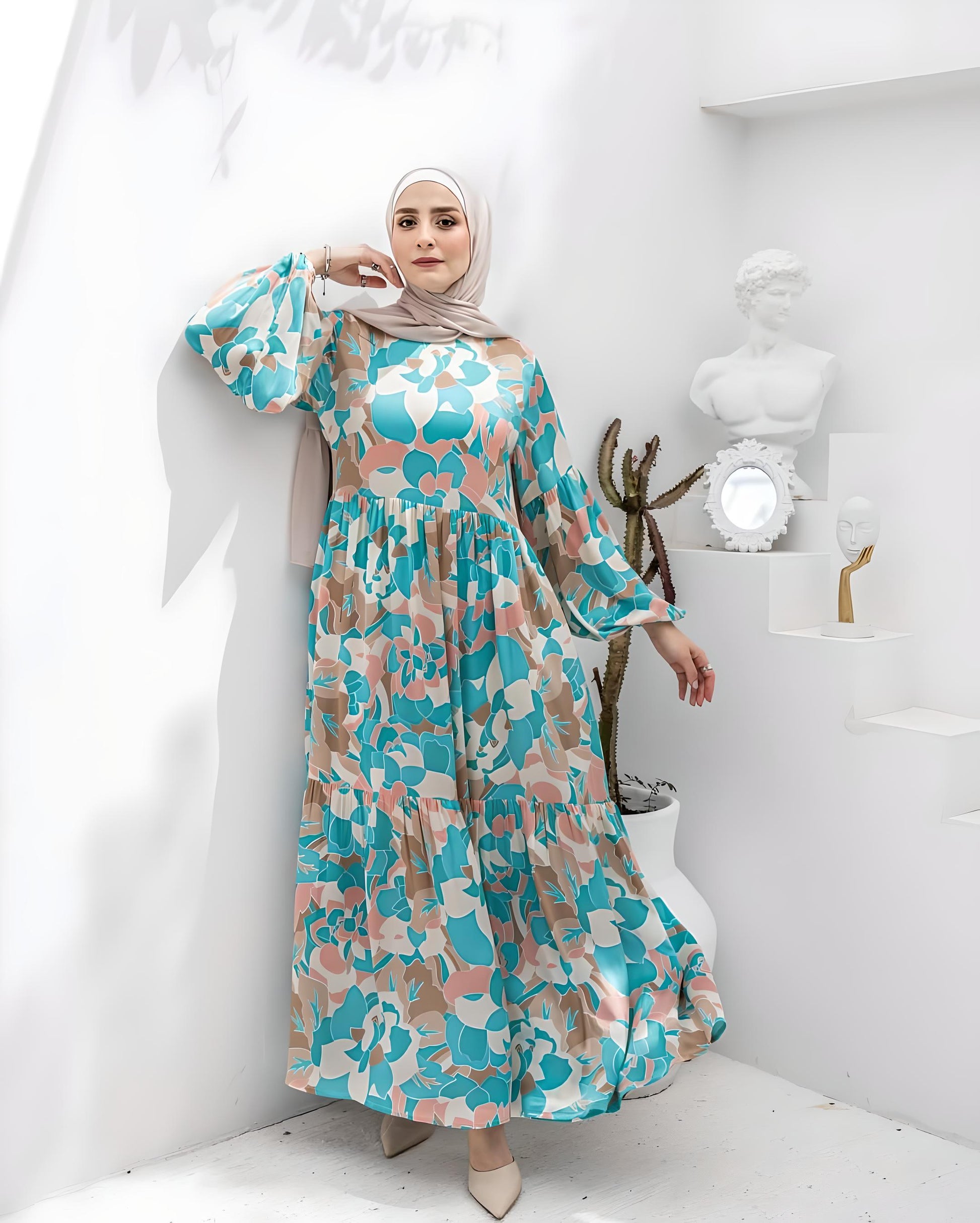 Woman wearing a chic blue floral print maxi dress with a beige hijab.