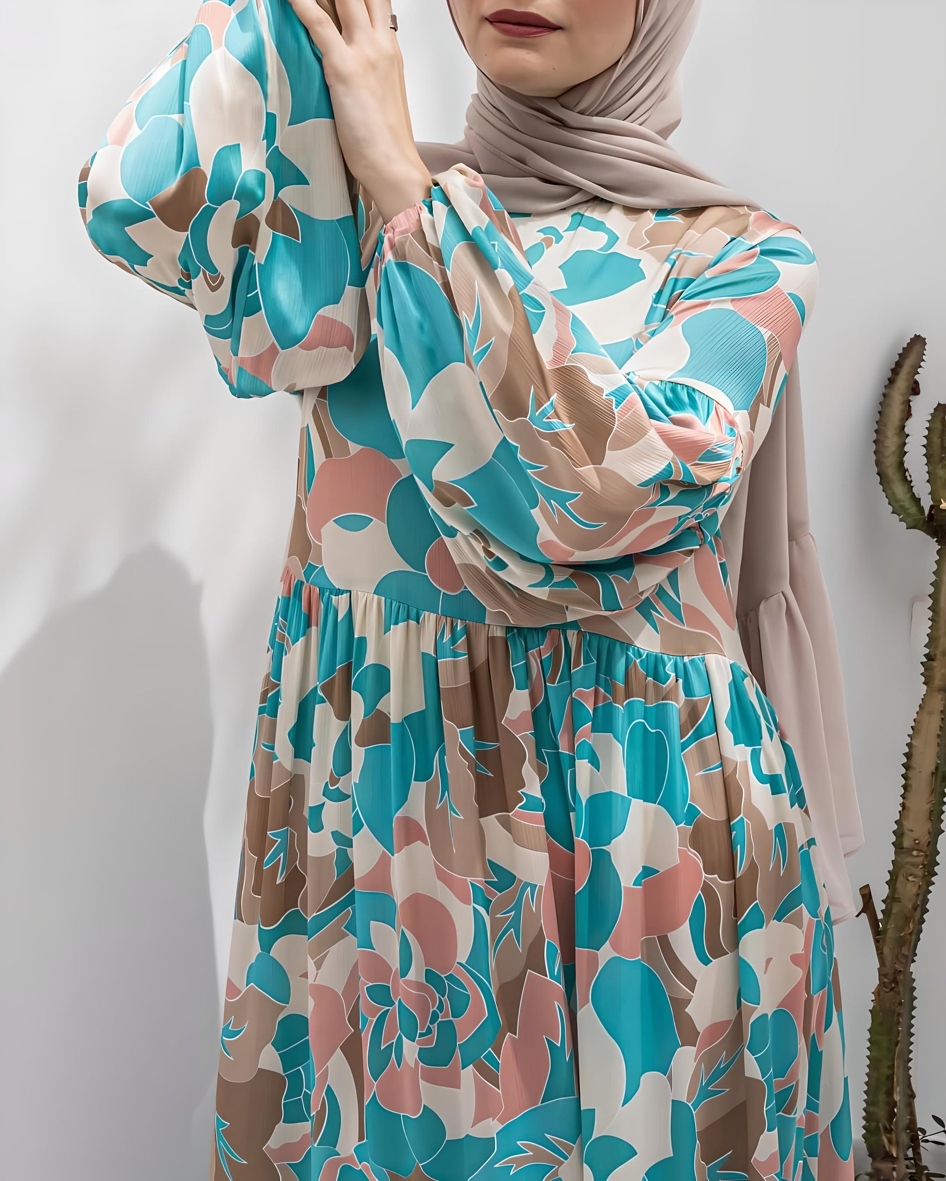 Stylish woman posing in a vibrant floral print dress and matching hijab.