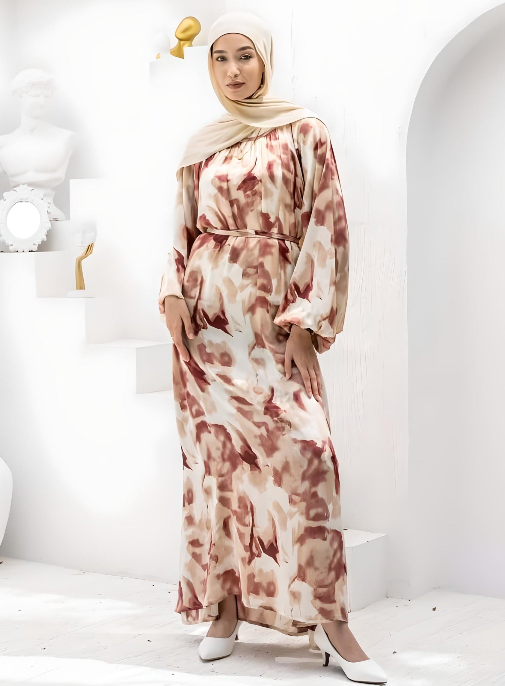 Woman wearing an elegant floral print maxi dress with a beige hijab