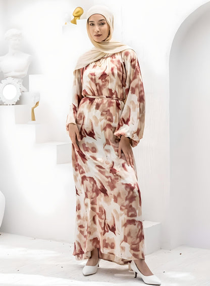 Woman wearing an elegant floral print maxi dress with a beige hijab