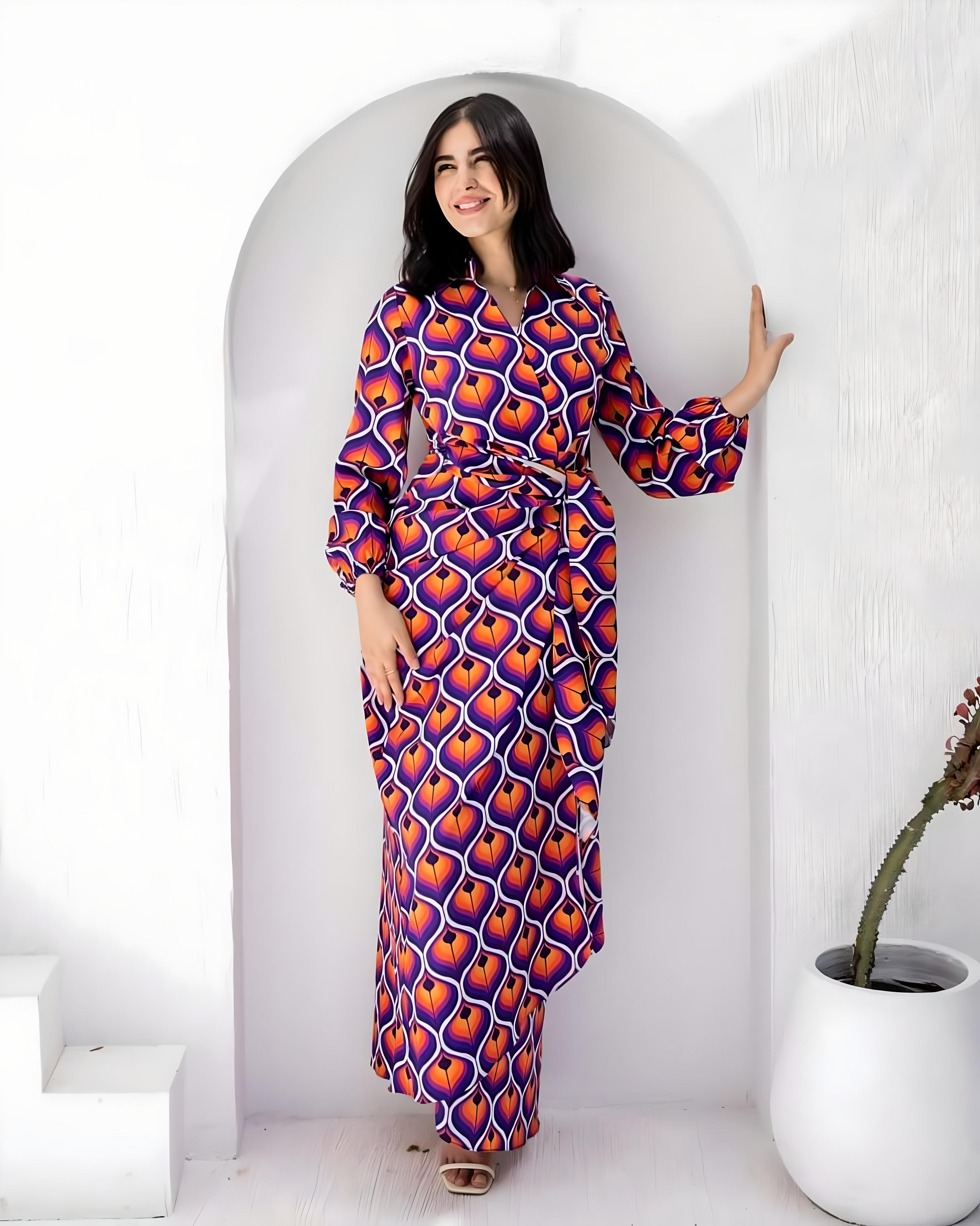 Woman wearing a bold geometric print crepe fabric maxi dress in vibrant colors.