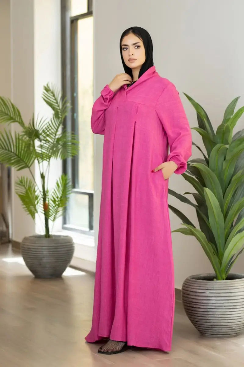 pink maxi dress with pleated front and elastic sleeves, made from Ketan fabric.