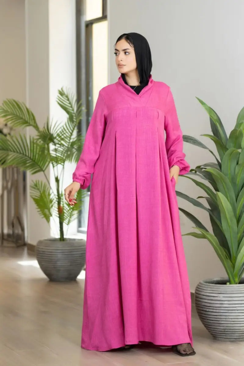 pink maxi dress with pleated front and elastic sleeves, made from Ketan fabric.