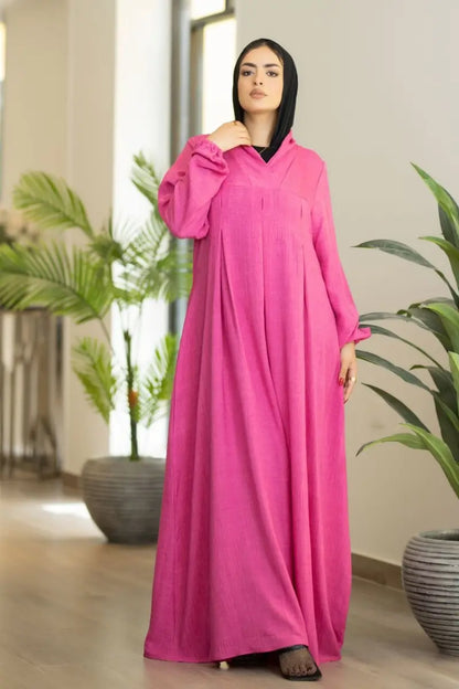 pink maxi dress with pleated front and elastic sleeves, made from Ketan fabric.