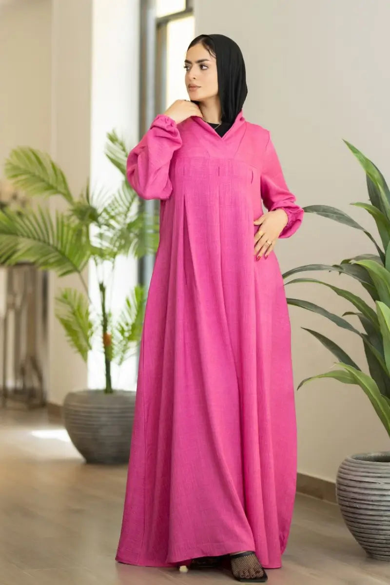 pink maxi dress with pleated front and elastic sleeves, made from Ketan fabric.