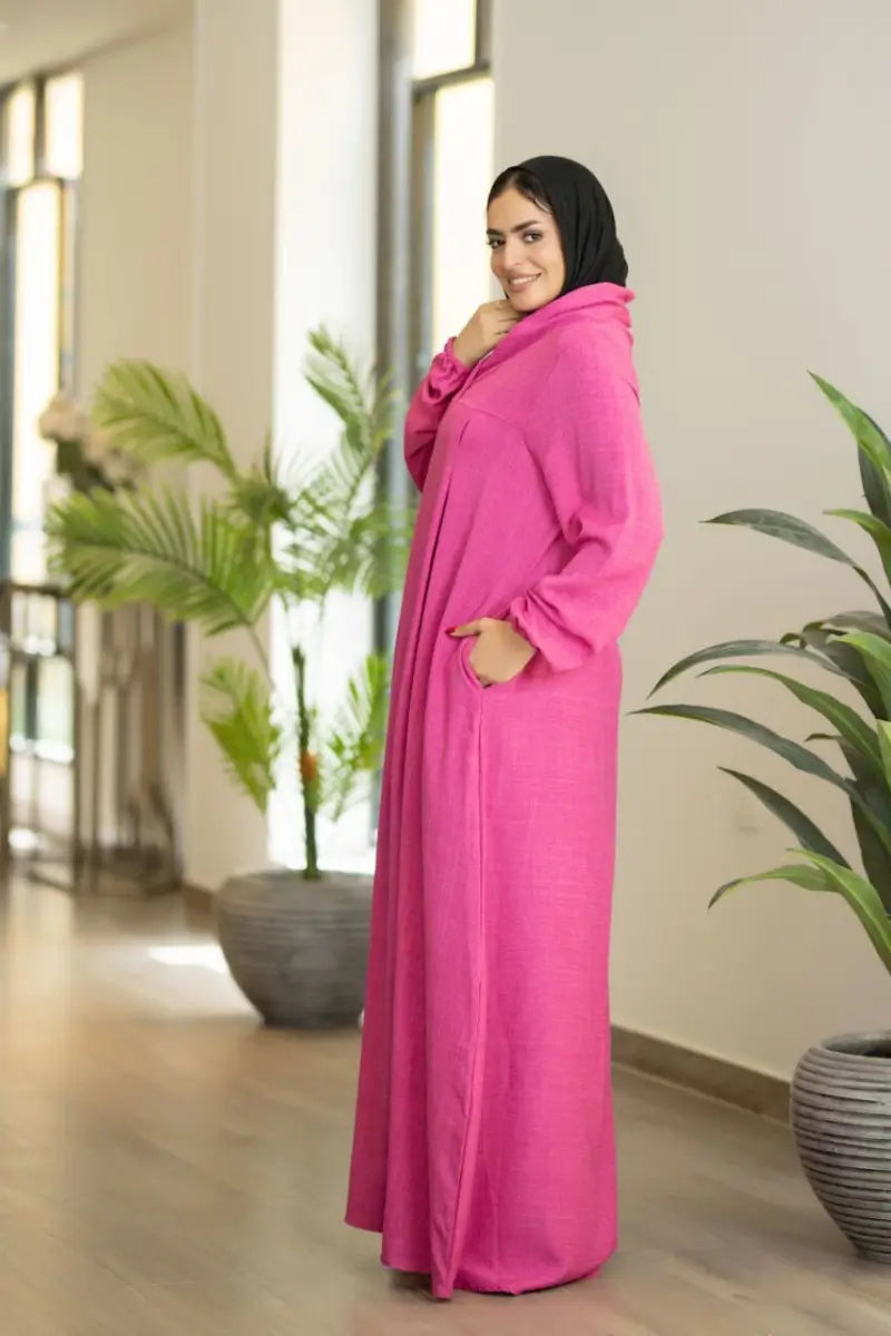 pink maxi dress with pleated front and elastic sleeves, made from Ketan fabric.